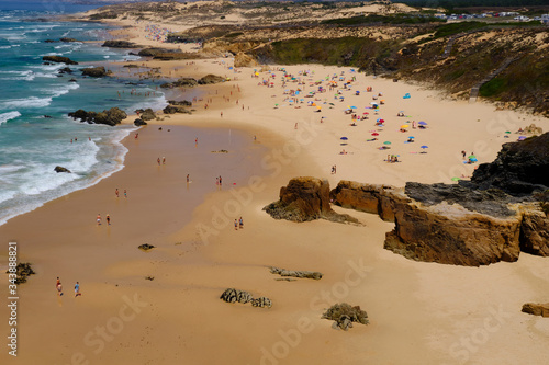 Beach Praia do Malhao. Solo Backpacker Trekking on the Rota Vicentina and Fishermen's Trail in Alentejo, Portugal. Walking between cliff, ocean, nature and beach. photo