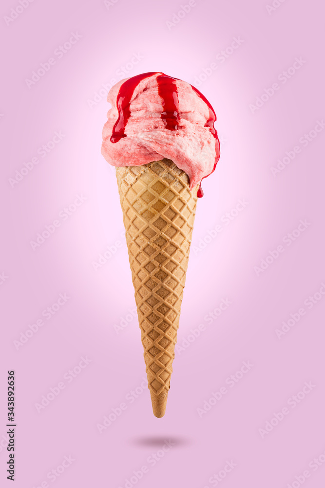 Strawberry ice cream cone with icing on colored background Strawberry ice cream cone with icing on colored background