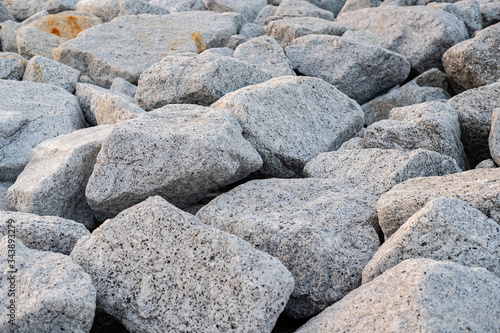 Close up. rock stone breakwater at the pier on the beach.