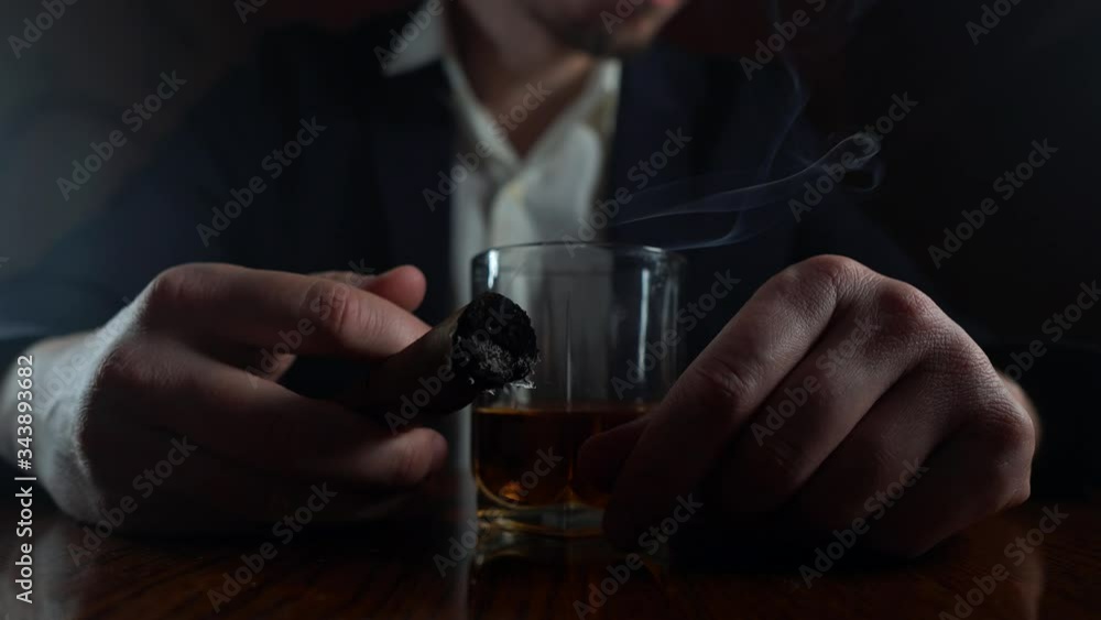 Stressed businessman. Сigar and alcohol in hand close up Stressed businessman. Сigar and alcohol in hand close up