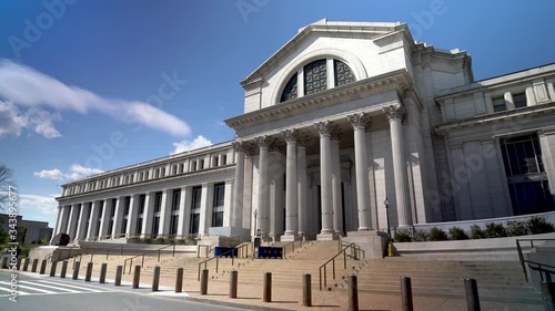 Turning steadicam shot to left showing Smithsonian Museum of Natural History in Washington, DC with a clear blue sky. photo