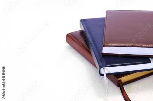 Stack of business planner or diaries isolated on white background. Top side view. 