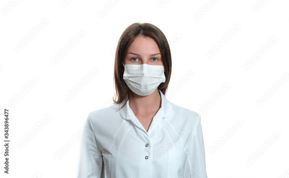 Young female nurse on camera wearing a surgical or medical mask. Doctor wearing a white coat isolated on white background. covid 19, coronavirus, quarantine Young female nurse on camera wearing a surgical or medical mask. Doctor wearing a white coat isolated on white background. covid 19, coronavirus, quarantine