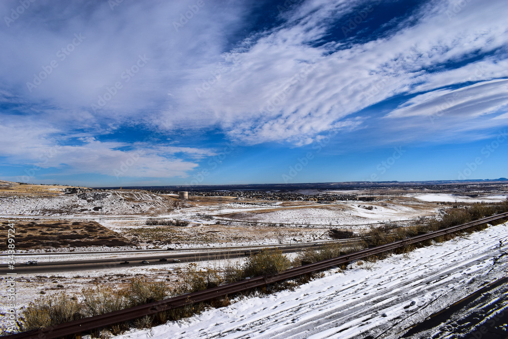 Snow covered road and highway with cloudy sky from Dinosaur Ridge, Colorado, USA