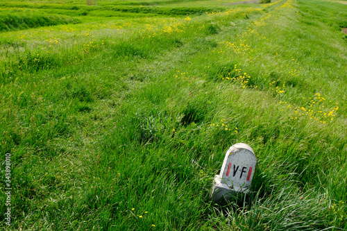 Sign on path in the green. Solo Backpacker Trekking on the Via Francigena from Lucca to Siena. Walking between nature, history, churches,