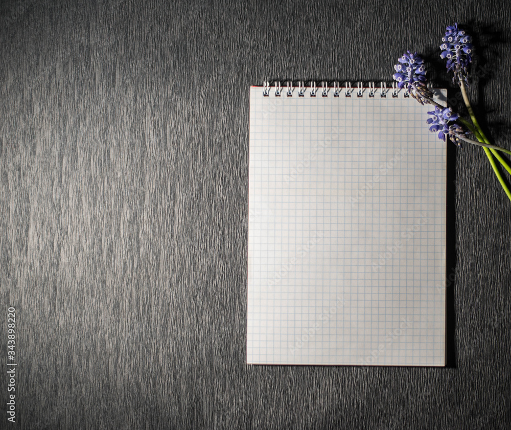 Notepad with flowers on a black background Notepad with flowers on a black background