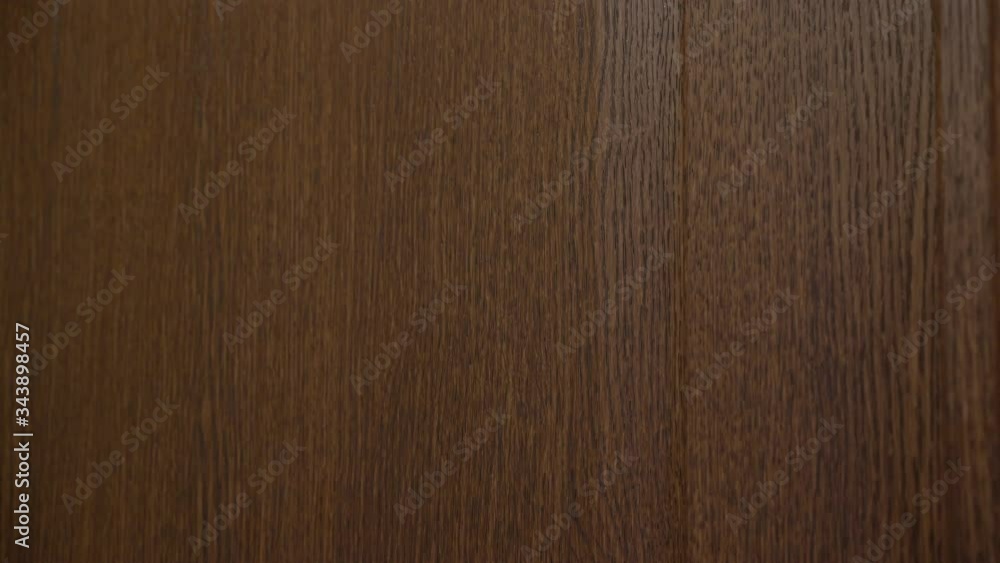 4K. Side view, a woman knocks with her fist on a brown wooden door . Close - up of the hand . 4K. Side view, a woman knocks with her fist on a brown wooden door . Close - up of the hand .