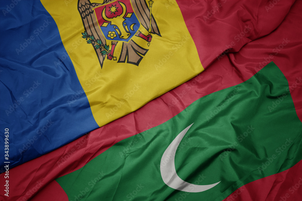 waving colorful flag of maldives and national flag of moldova. waving colorful flag of maldives and national flag of moldova.