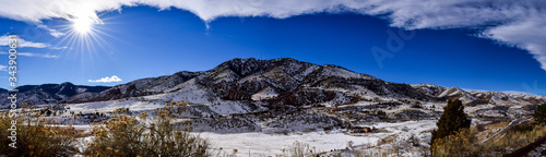 Panoramic view of snow-covered Rockies in the sun from Dinosaur Ridge, Colorado, USA