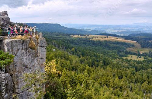 Tourists admiring view from viewing terrace atop Szczeliniec Wielki peak in Table Mountains, Poland