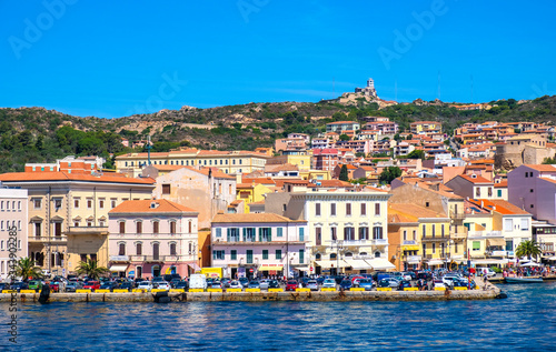 Panoramic view of La Maddalena old town quarter in Sardinia, Italy with port at the Tyrrhenian Sea coastline and island mountains interior in background