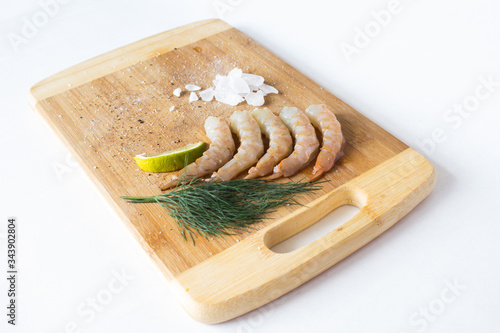 Juicy and fresh prawns on a wooden chopping Board photo