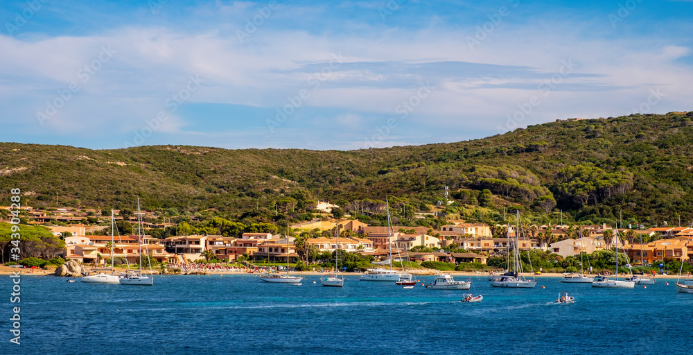 Panoramic view of La Maddalena old town quarter in Sardinia, Italy with port at the Tyrrhenian Sea coastline and island mountains interior in background