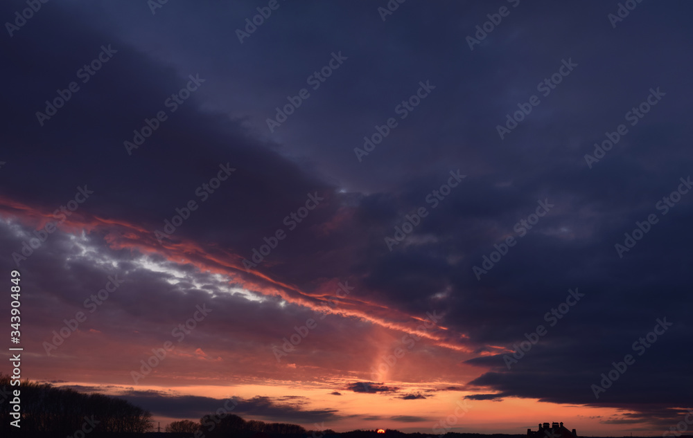 Evening. Terrible, cloudy, sky.
Panoramic photographic image, lighting of the sky above the horizon at sunset.