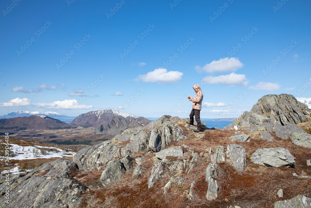 Happy woman on a hike to Salbuhatten mountain in Brønnøy municipality, Nordland county