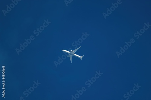 Ein wei  es Flugzeug fliegt vor blauem Himmel  Illustration von Verkehr Urlaub  Reise  Klimawandel