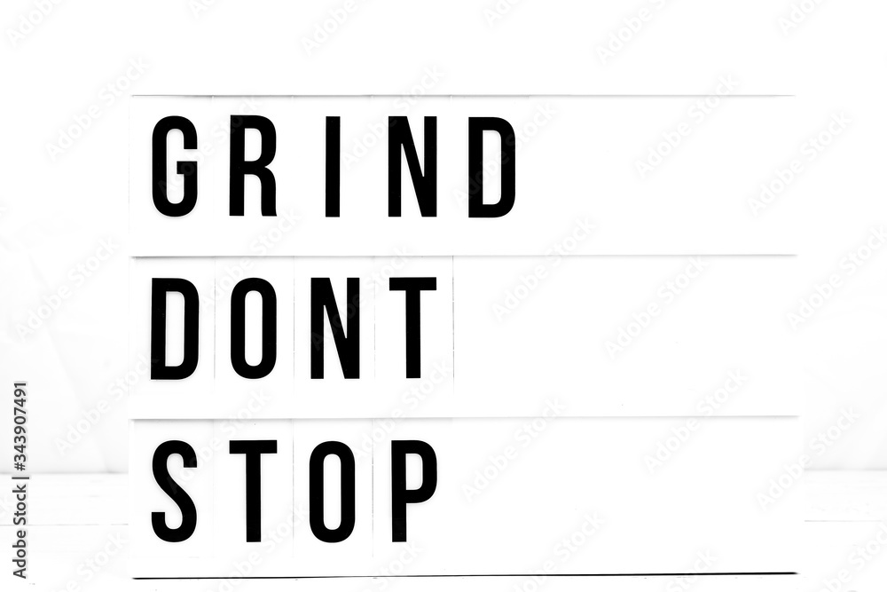Fototapeta Inspirational Grind Don't Stop quote on vintage retro board. Concept. flat lay