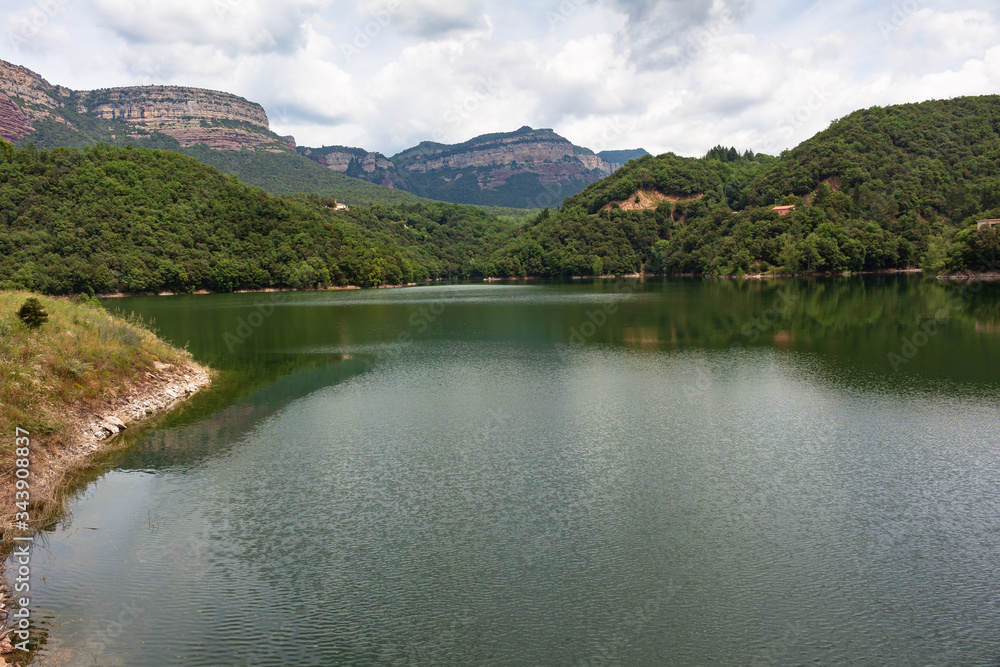 View of the Sau reservoir at 95% of its capacity with the Collsacabra cliffs in the background. Catalonia, Spain.
