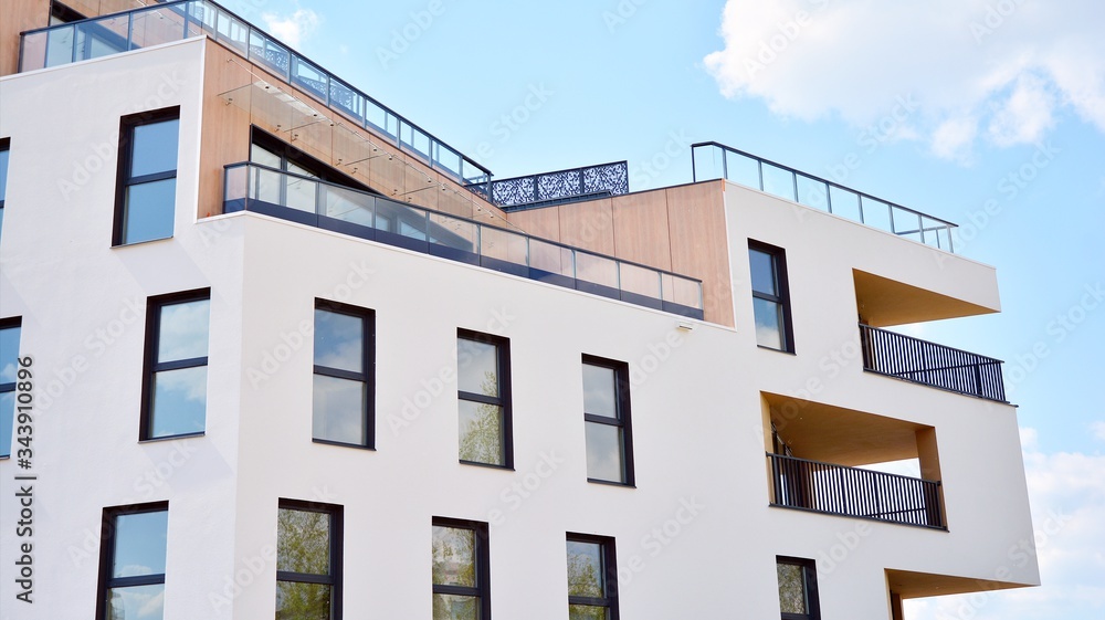 Contemporary residential building exterior in the daylight. Modern apartment buildings on a sunny day with a blue sky. Facade of a modern apartment building Contemporary residential building exterior in the daylight. Modern apartment buildings on a sunny day with a blue sky. Facade of a modern apartment building