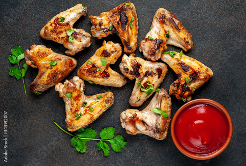 Grilled chicken wings in barbecue sauce on a concrete background