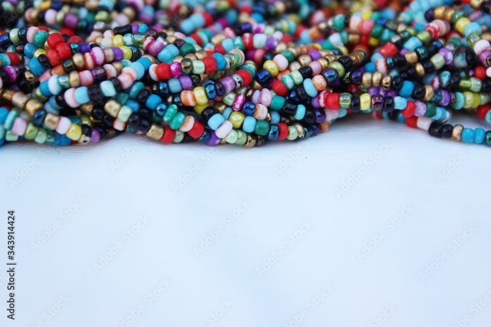 Multicolored small beads top view. Multicolored beads closeup with place for text. Multicolored beads top view. Abstraction of balls of different colors. Colorful bright background of small spheres.