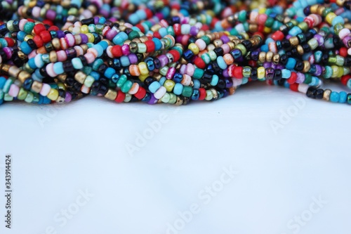Obraz na płótnie Multicolored small beads top view. Multicolored beads closeup with place for text. Multicolored beads top view. Abstraction of balls of different colors. Colorful bright background of small spheres. w salonie