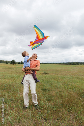 A family flies a kite on the field.