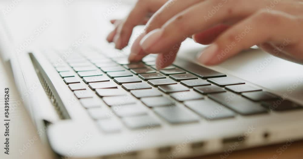 Close up view of female hands typing on laptop computer Close up view of female hands typing on laptop computer