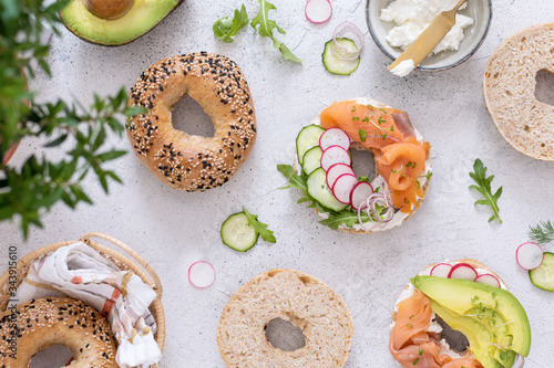 Breakfast flat lay of New York style bagels with philadelphia cheese, avocado, cured salmon