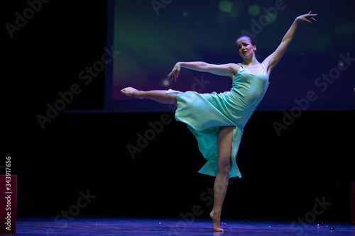 Dancer actresses young woman performs on theatrical scene in the musical show dance
