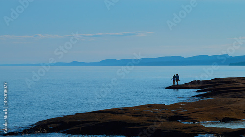two women silhouetted, lake superior