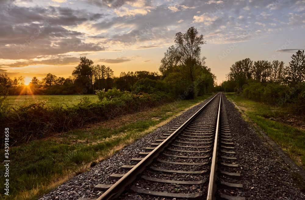 Fototapeta premium Old railroad tracks at sunset