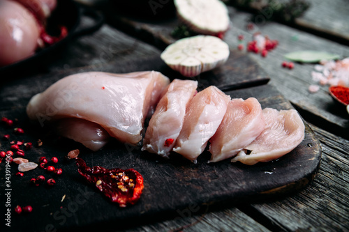 Raw Chicken Fillet on a Cutting Board