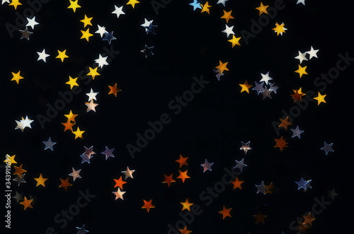 Golden stars confetti on black background with copy space, Festive, holiday, ...