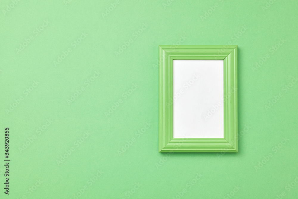 Green frame for painting or picture on coloful background Top view Green frame for painting or picture on coloful background Top view