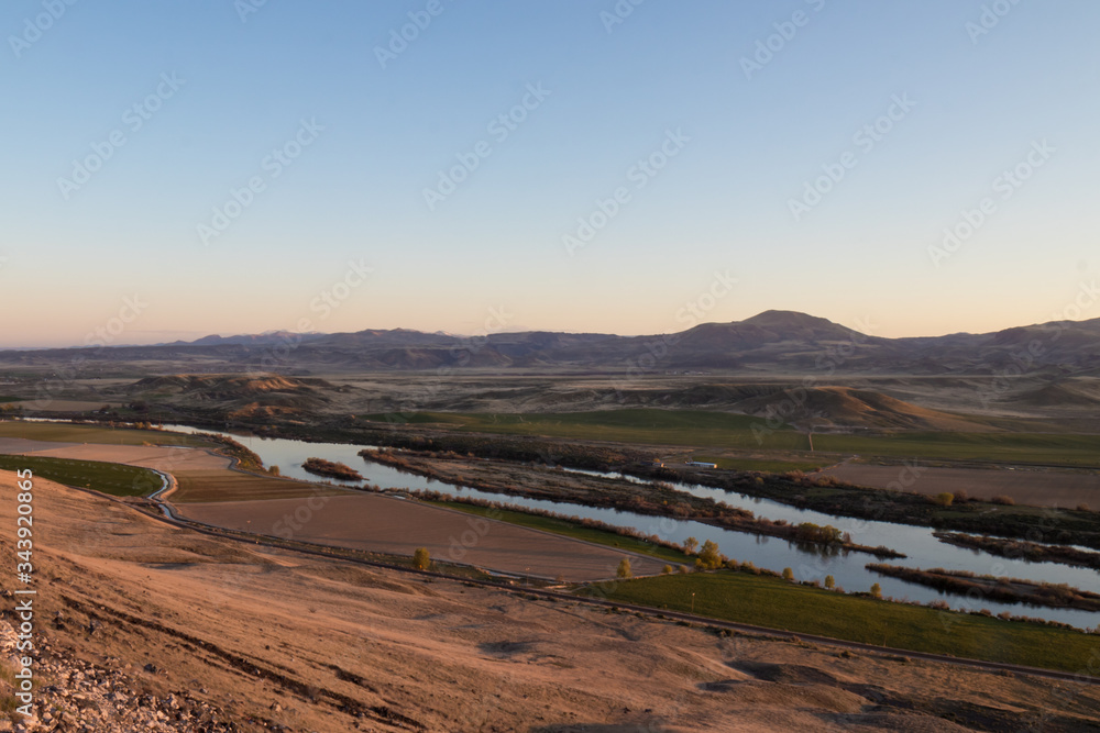 snake river and owyhees in background during sunset on a spring evening in southern idaho