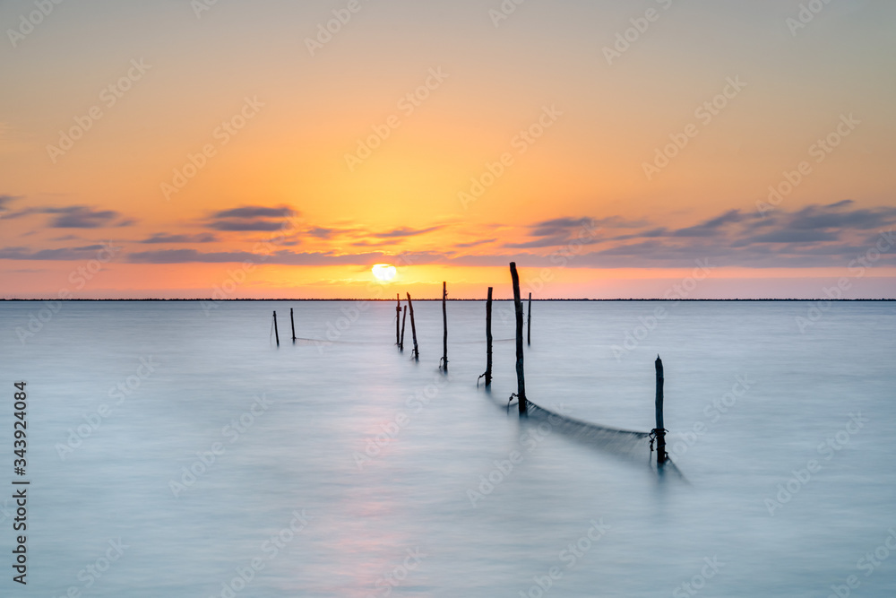 Fishing nets in a lake during the sunset