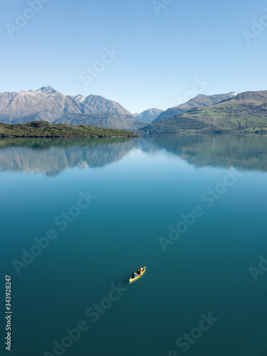 Aerial view of a two people paddling a canoe on Lake Wakitipu, Otago region, South Island, New Zealand photo