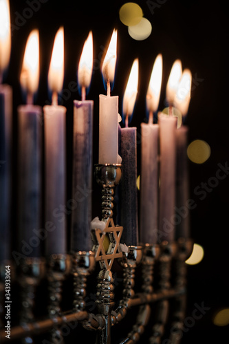 Lit candles in menorah photo