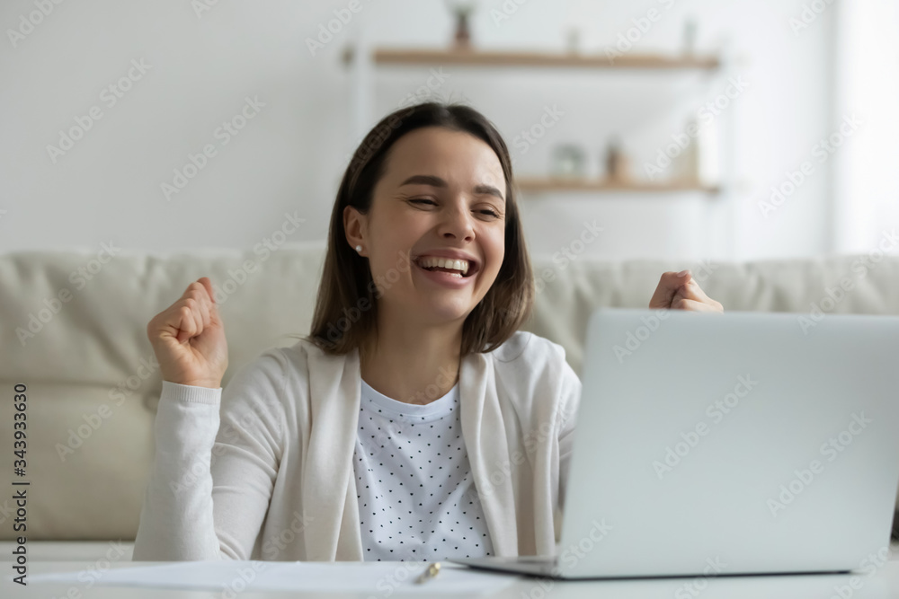 Overjoyed millennial girl look at laptop screen triumph winning online lottery, happy young woman feel excited read unexpected good pleasant news or message on computer, luck, reward concept Overjoyed millennial girl look at laptop screen triumph winning online lottery, happy young woman feel excited read unexpected good pleasant news or message on computer, luck, reward concept
