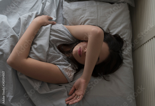 Elevated view of young woman sleeping in bed