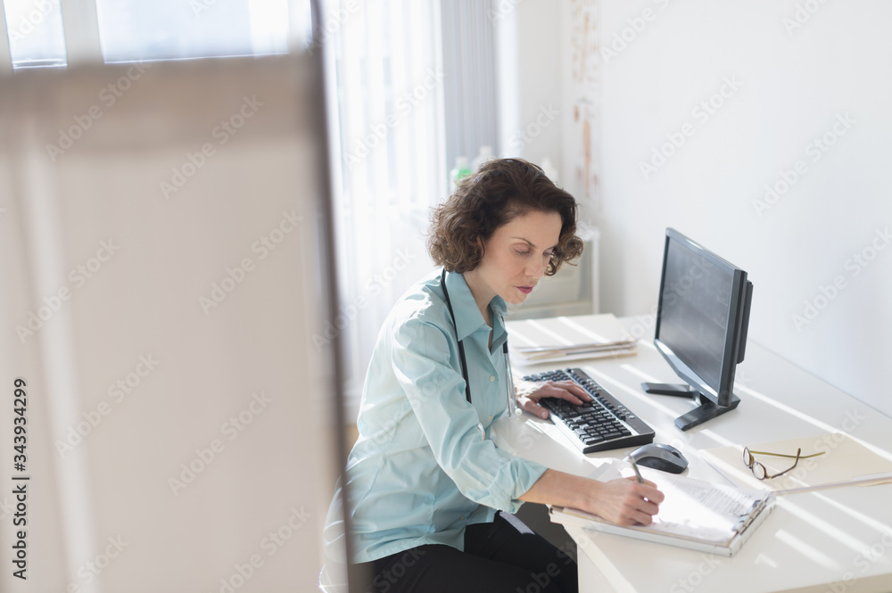 Female doctor doing notes Female doctor doing notes