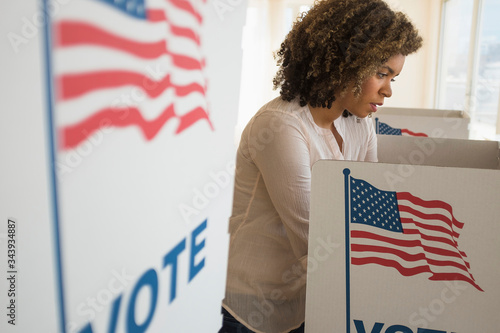 Young woman in voting booth photo