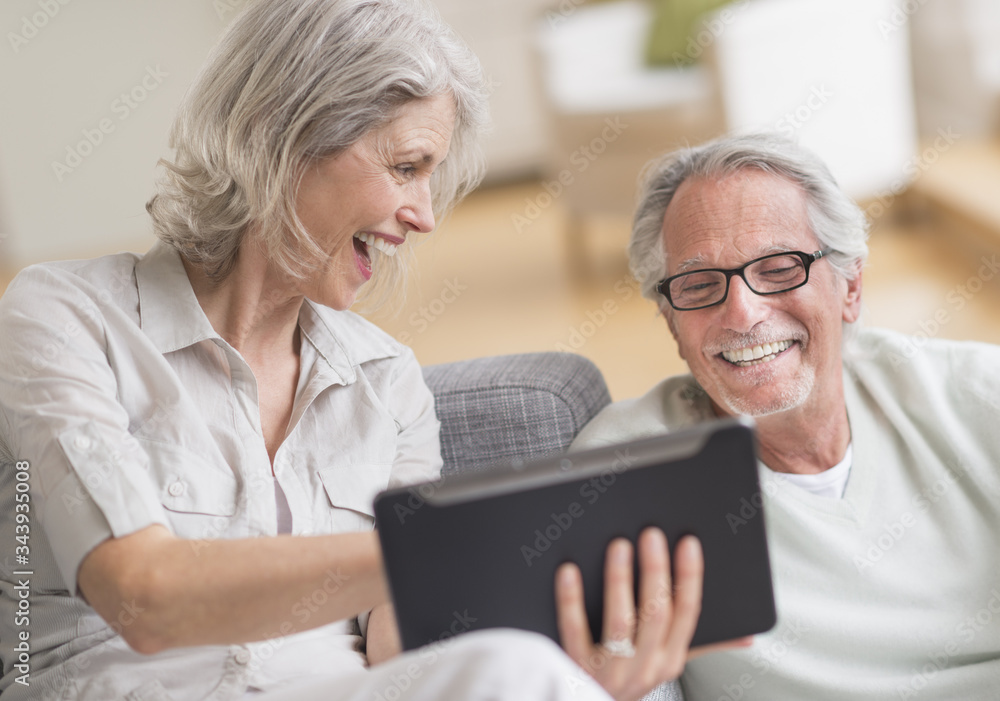 Senior couple using digital tablet at home Senior couple using digital tablet at home