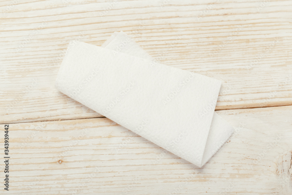 white paper napkin with a textured pattern on an old table white paper napkin with a textured pattern on an old table
