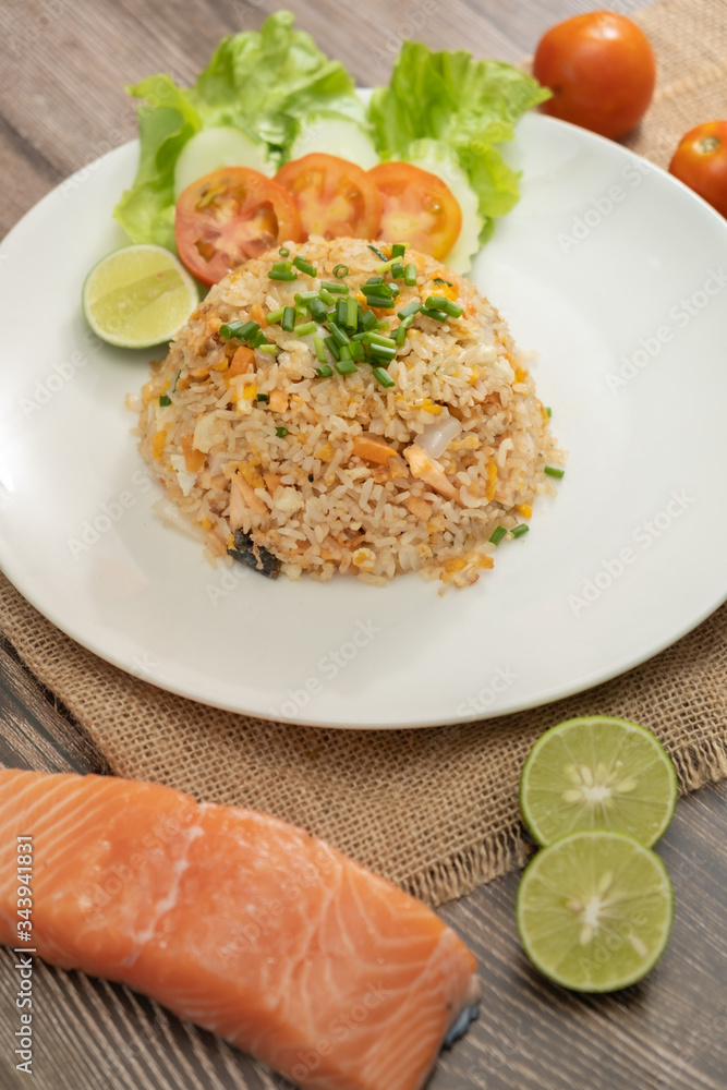 Fried rice with egg and grilled salmon on the white plate -Stock photo