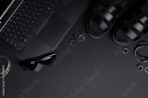 Monochrome composition with laptop, clothing and accessories. Online shopping cyber monday black friday concept