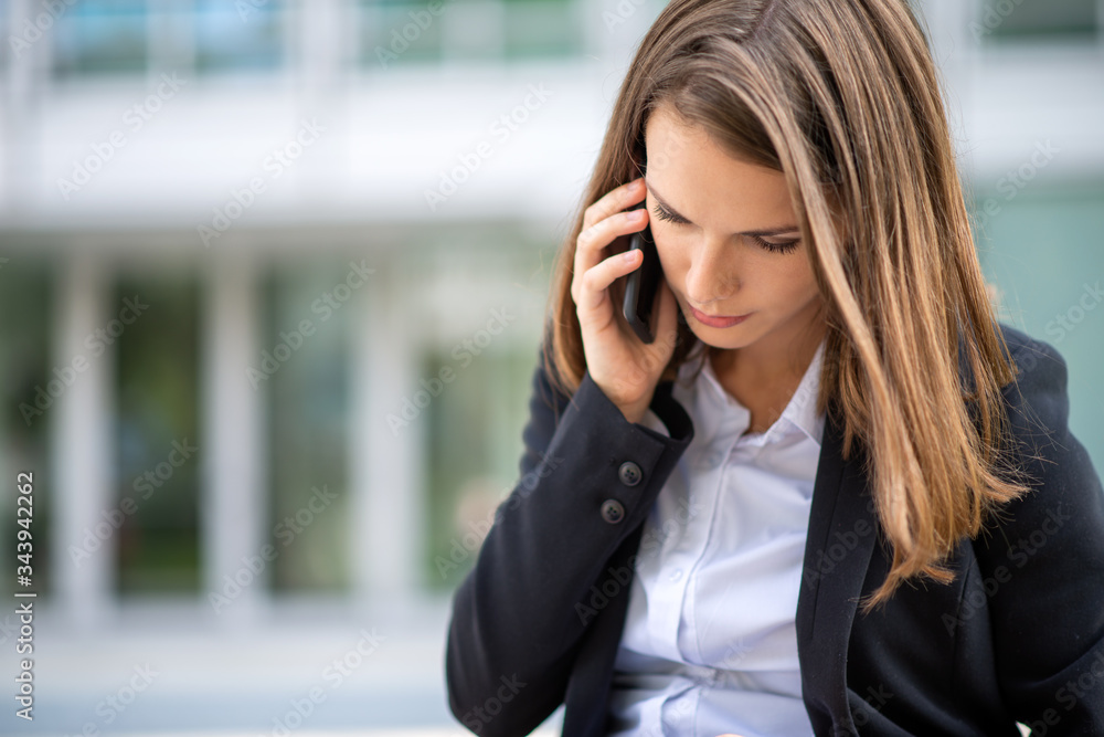Young business woman talking on her cellphone Young business woman talking on her cellphone