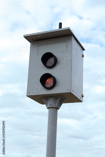 camera monitoring the speed of cars against a blue sky