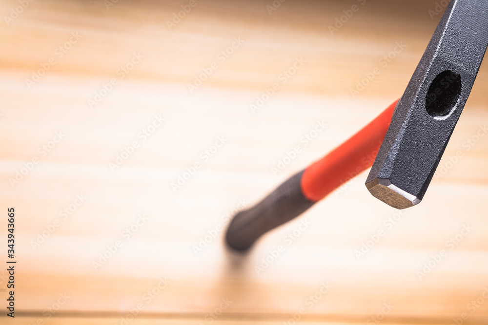 quality hammer on a wooden table. focus on the iron hammer, blurred background. space for text. copy space quality hammer on a wooden table. focus on the iron hammer, blurred background. space for text. copy space